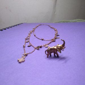 A taste of India gold tone necklace with elephant pin charm